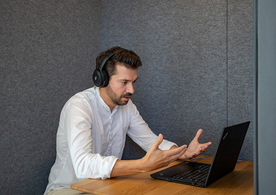 person with headphones in a client video call (Photo)