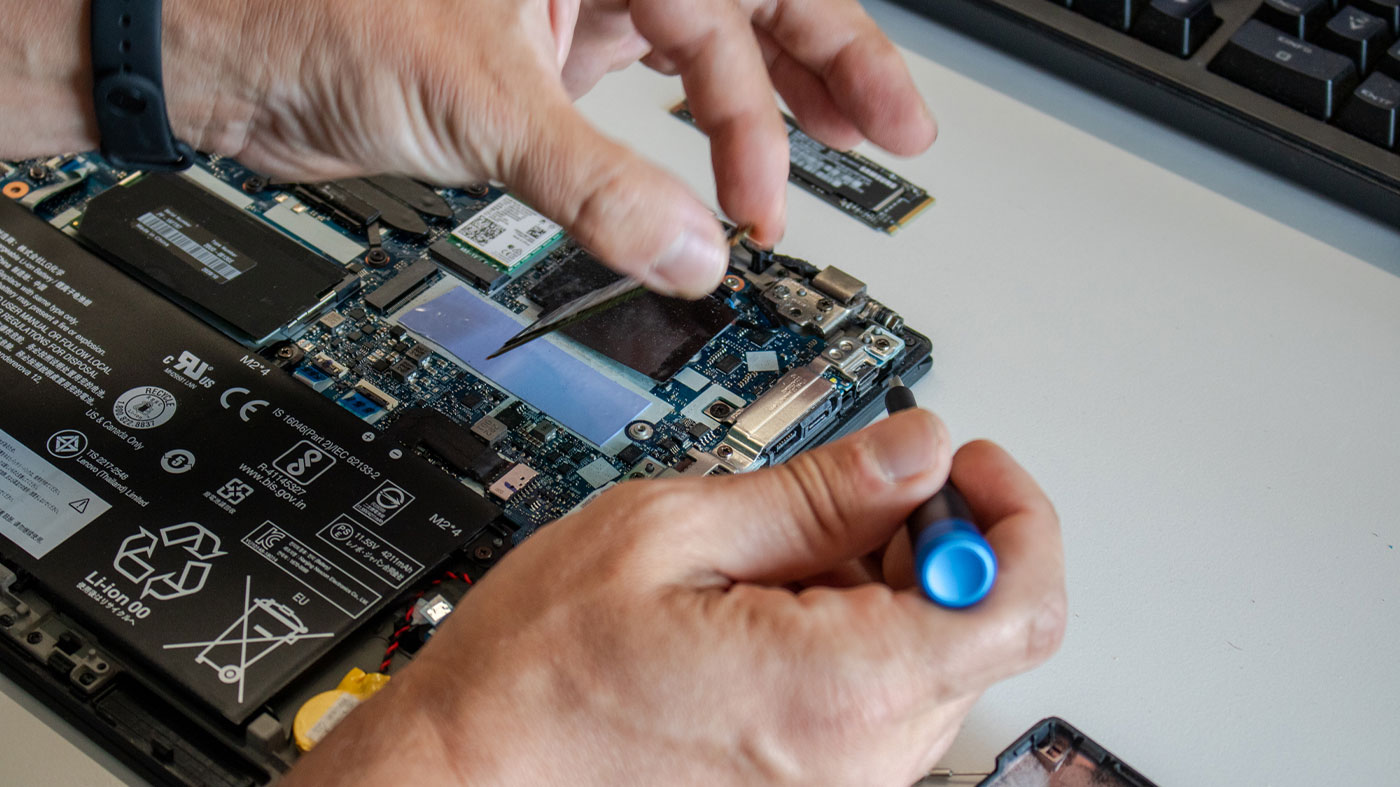 closeup of a person fixing laptop wiring (Photo)